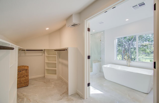 bathroom featuring separate shower and tub and lofted ceiling