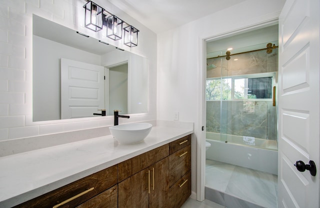 full bathroom featuring tile patterned flooring, vanity, toilet, and shower / bath combination with glass door