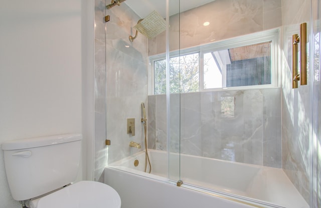 bathroom with toilet and enclosed tub / shower combo