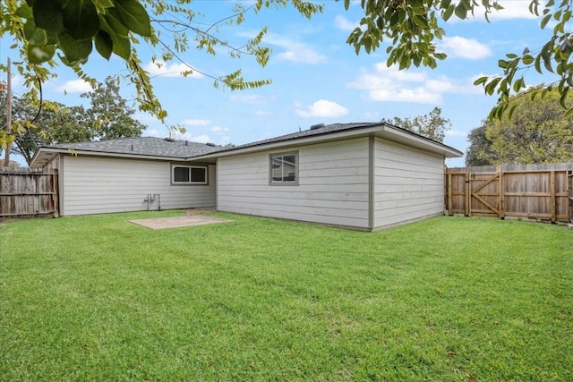 back of property with a yard and a patio