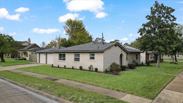 single story home featuring a front yard and a garage