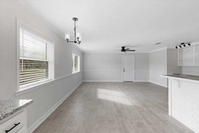 unfurnished living room with ceiling fan with notable chandelier, light hardwood / wood-style floors, and ornamental molding