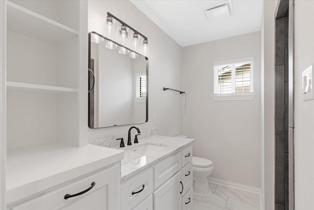 bathroom with vanity and toilet