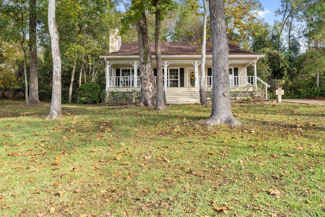 view of front of property with covered porch and a front yard