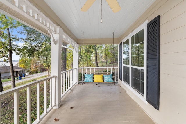 balcony featuring ceiling fan and a porch