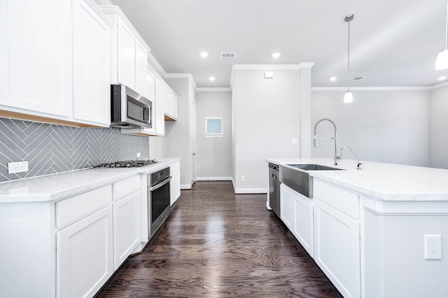 kitchen featuring sink, decorative light fixtures, dark hardwood / wood-style flooring, white cabinetry, and stainless steel appliances