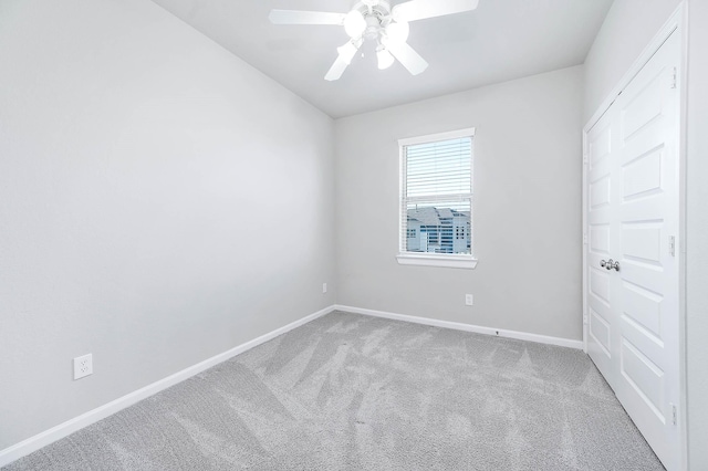 carpeted empty room with ceiling fan