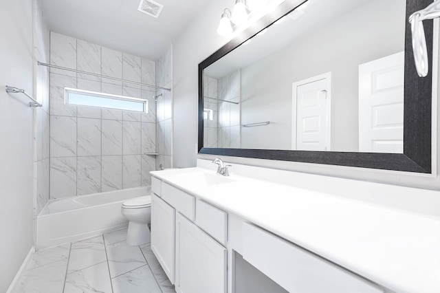 full bathroom with vanity, tiled shower / bath combo, and toilet