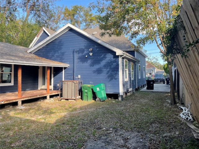 rear view of property with a lawn and a wooden deck