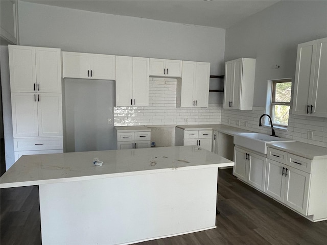 kitchen featuring white cabinets, sink, and a kitchen island