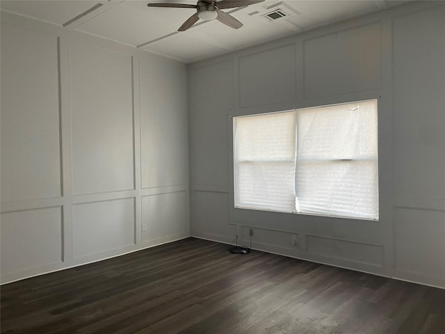 empty room with dark hardwood / wood-style floors and ceiling fan