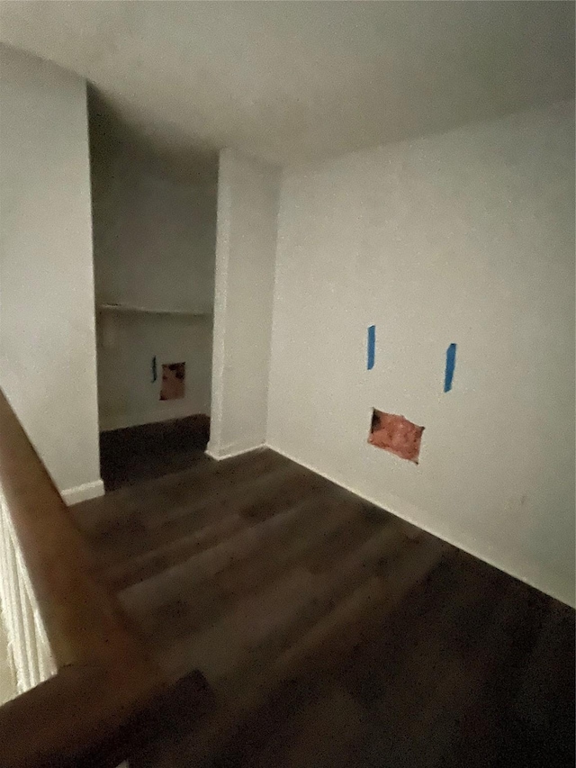 laundry area featuring dark wood-type flooring