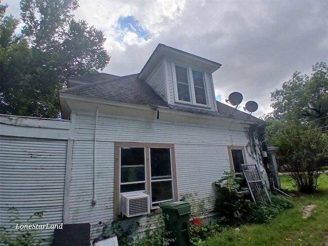 view of side of home featuring cooling unit