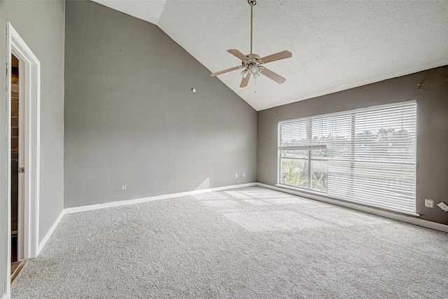 spare room with light carpet, a textured ceiling, high vaulted ceiling, and ceiling fan