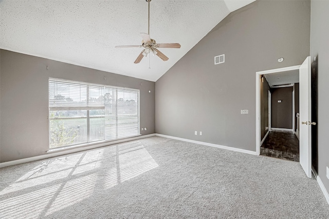 carpeted spare room with ceiling fan, a textured ceiling, and high vaulted ceiling