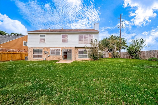 rear view of house featuring a lawn