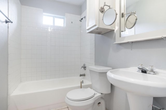 full bathroom featuring sink, toilet, and tiled shower / bath