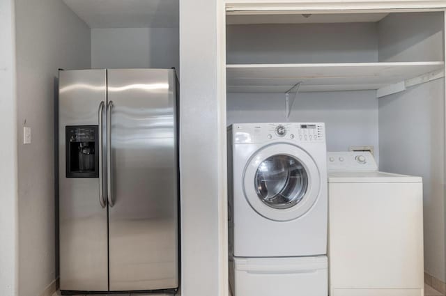 clothes washing area with washing machine and clothes dryer