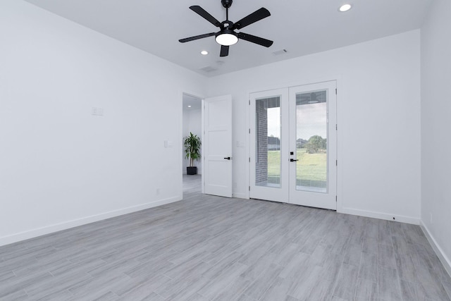 spare room featuring ceiling fan, french doors, and light hardwood / wood-style flooring