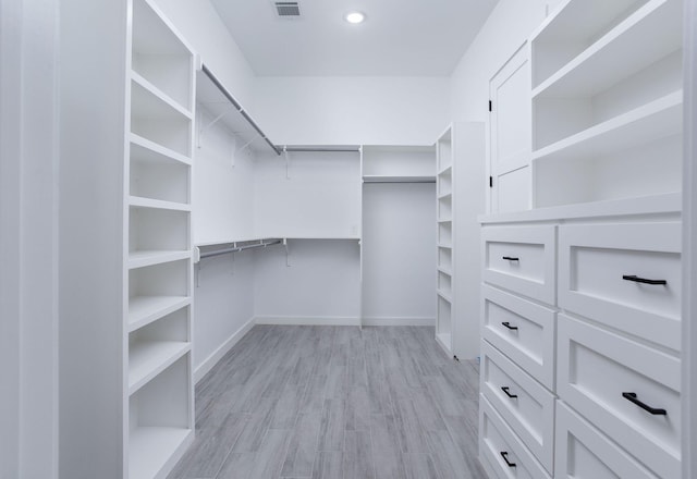 spacious closet with light hardwood / wood-style floors