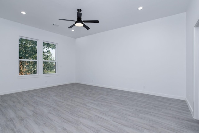 unfurnished room with ceiling fan and light hardwood / wood-style flooring