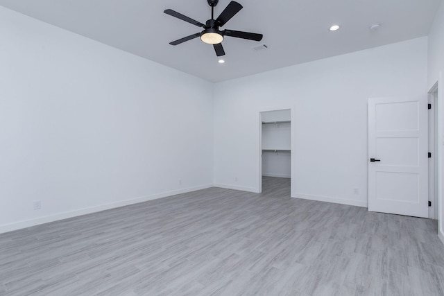 unfurnished room with ceiling fan and light wood-type flooring