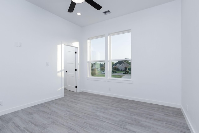 spare room with ceiling fan and light hardwood / wood-style floors