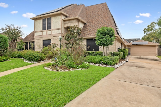 view of front of property with a front yard and a garage