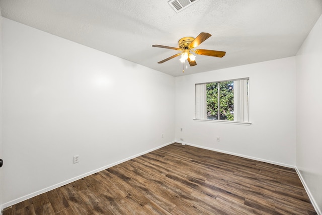 empty room featuring a textured ceiling, ceiling fan, and dark hardwood / wood-style floors