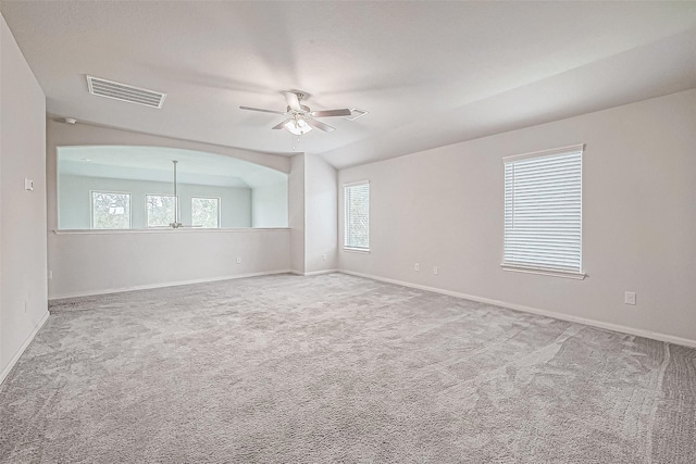 spare room with ceiling fan, plenty of natural light, and carpet floors