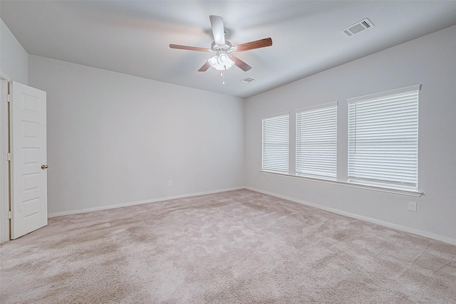 empty room with light colored carpet and ceiling fan