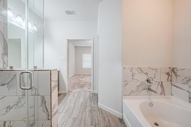 bathroom featuring shower with separate bathtub, vanity, and hardwood / wood-style flooring