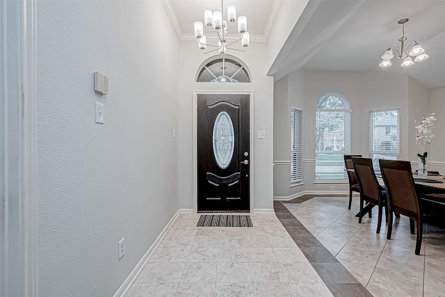 foyer featuring light tile patterned floors, an inviting chandelier, and crown molding