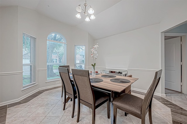 tiled dining area with a chandelier and vaulted ceiling