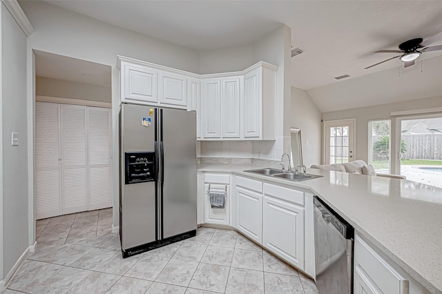 kitchen with lofted ceiling, sink, ceiling fan, white cabinetry, and stainless steel appliances