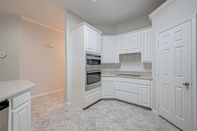 kitchen featuring light tile patterned floors, white cabinetry, appliances with stainless steel finishes, and tasteful backsplash