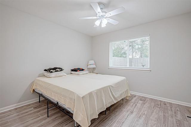 bedroom with light hardwood / wood-style flooring and ceiling fan