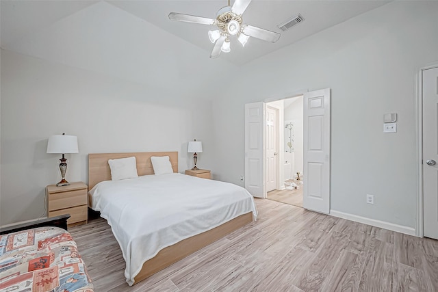 bedroom with light hardwood / wood-style flooring, ceiling fan, and lofted ceiling