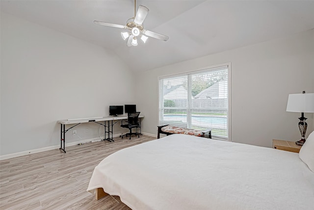 bedroom with ceiling fan, light wood-type flooring, and vaulted ceiling