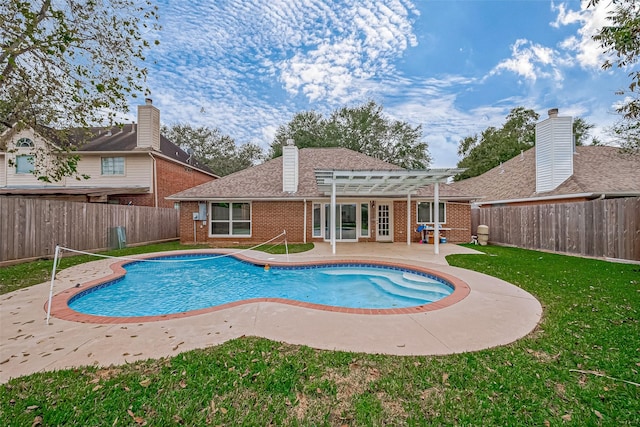 view of swimming pool featuring a lawn and a patio area