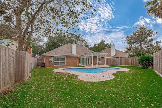 view of pool with a yard and a patio