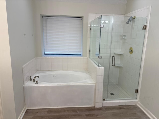 bathroom with plus walk in shower and hardwood / wood-style flooring