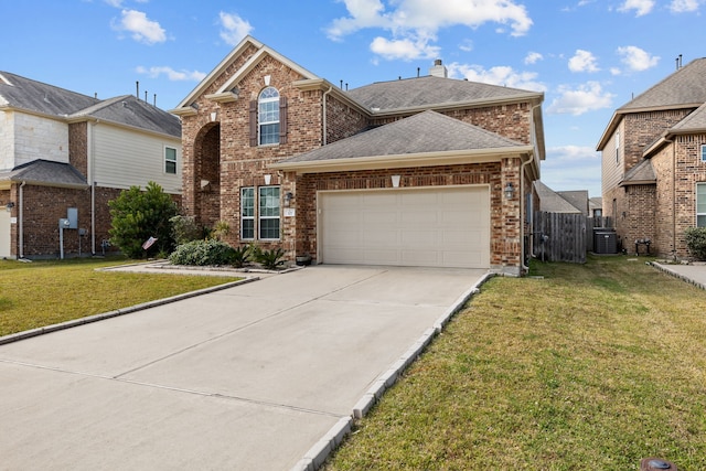 front of property with a front yard, a garage, and central AC unit