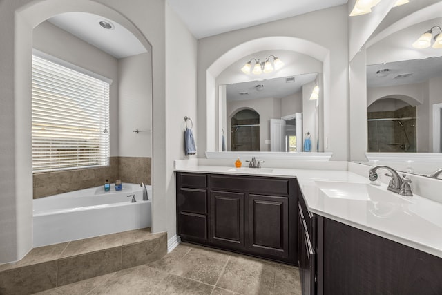 bathroom with vanity and independent shower and bath