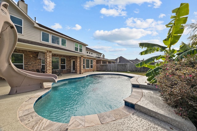 view of pool featuring a patio and a water slide