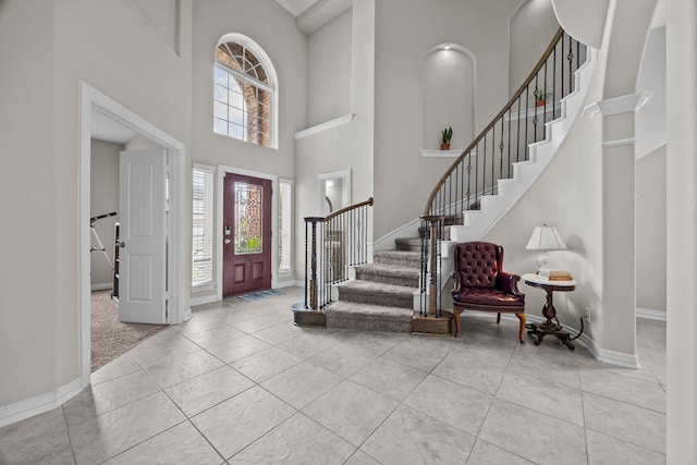 tiled foyer entrance with a towering ceiling