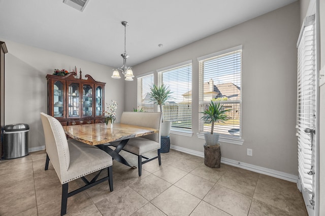 dining space featuring light tile patterned floors and a notable chandelier