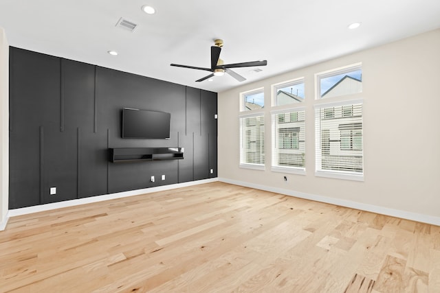 unfurnished living room featuring light hardwood / wood-style flooring and ceiling fan