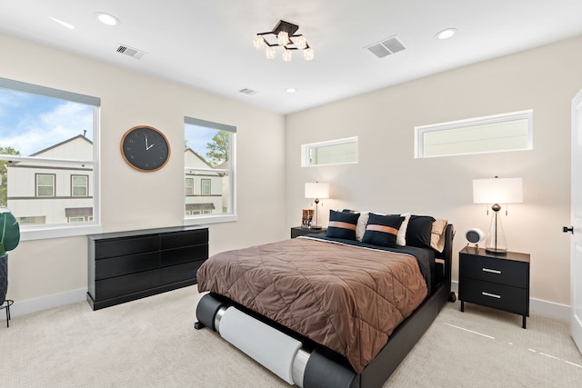 carpeted bedroom with multiple windows