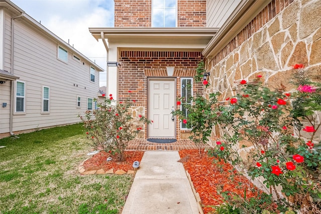 doorway to property with a yard